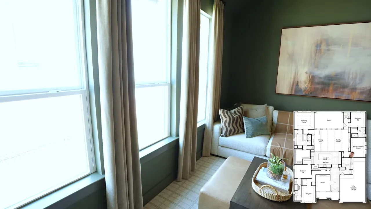 Green game room with sectional sofa wall mounted television and large windows