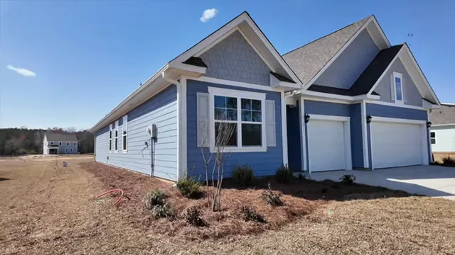 Large unfinished three-car garage with extended storage space