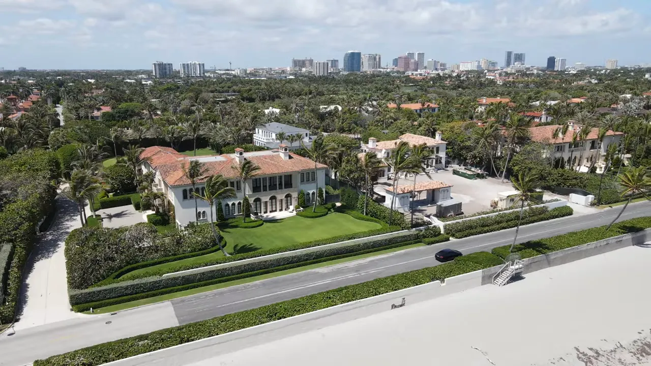 Text slide over waterfront background reading: 'New listings in Palm Beach increased by 15.9% in October 2023.'