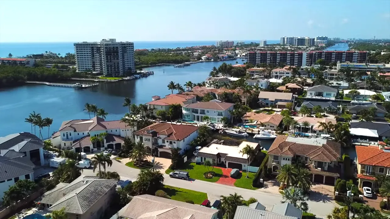 Wide aerial image of Bel Marra neighborhood with canals and waterfront homes outlined in turquoise.