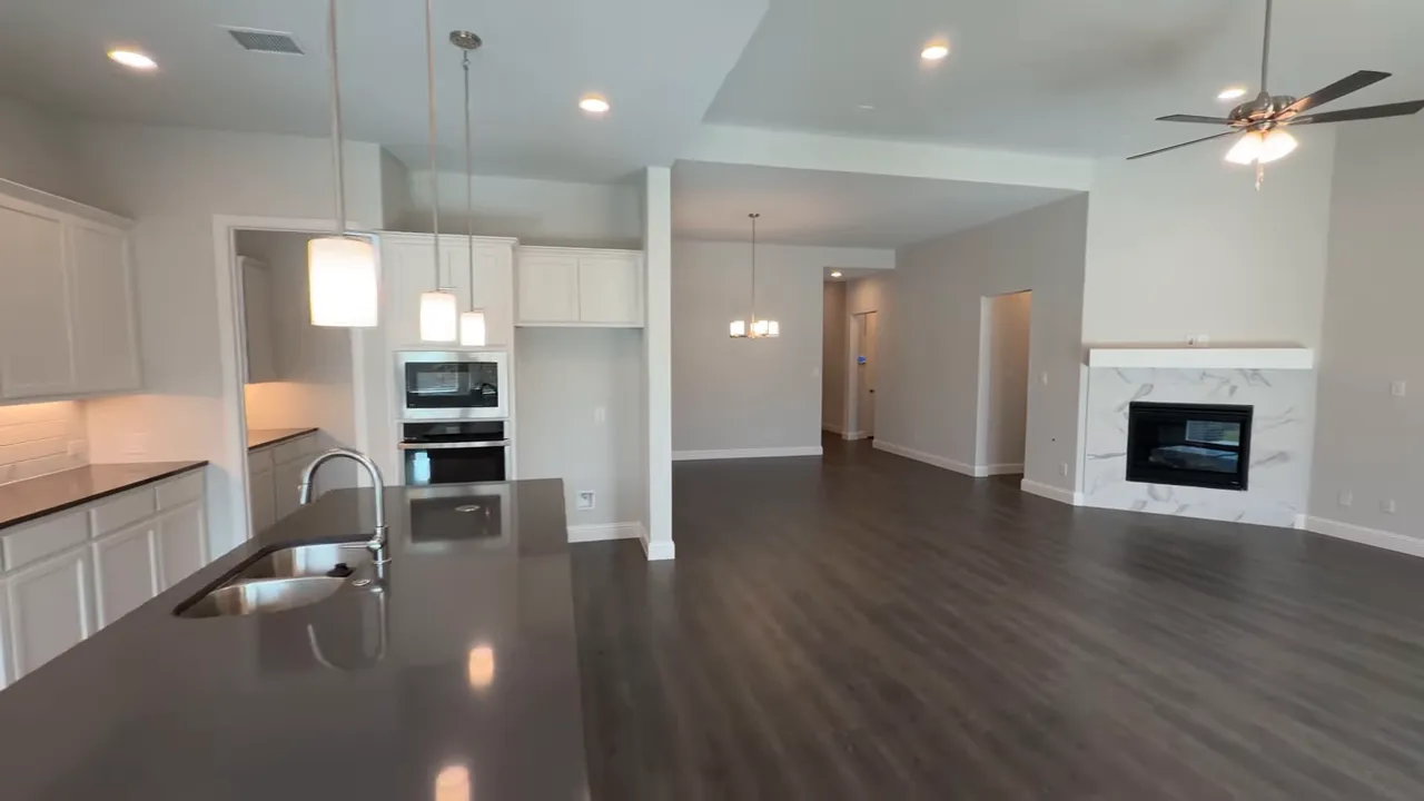 primary bathroom featuring a freestanding tub, glass-enclosed shower and marble-look tile