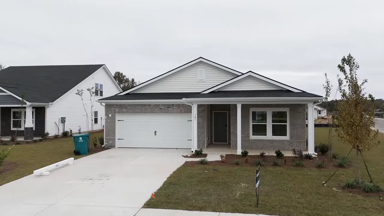 Front of four-bedroom home on a cul-de-sac with front porch and brick accents