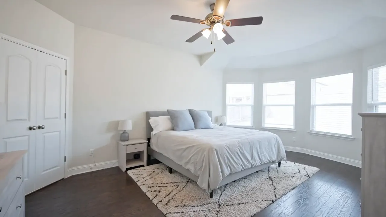primary bathroom with soaking tub, glass shower, double vanity and walk-in closet entrance