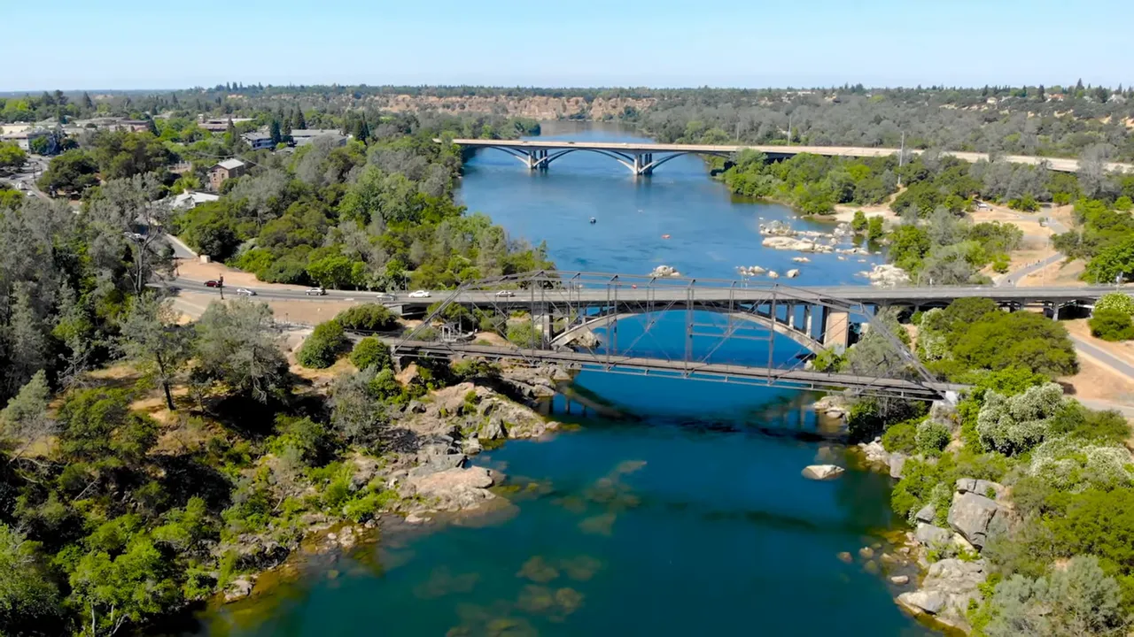 New-construction single-family model homes with clean landscaping and a clear blue sky, representing newer communities.