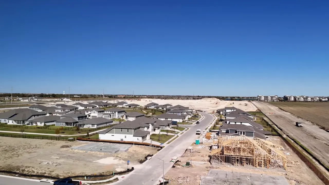 Aerial shot of Lake Pflugerville shoreline and walking trail with text overlay '180-acre lake'