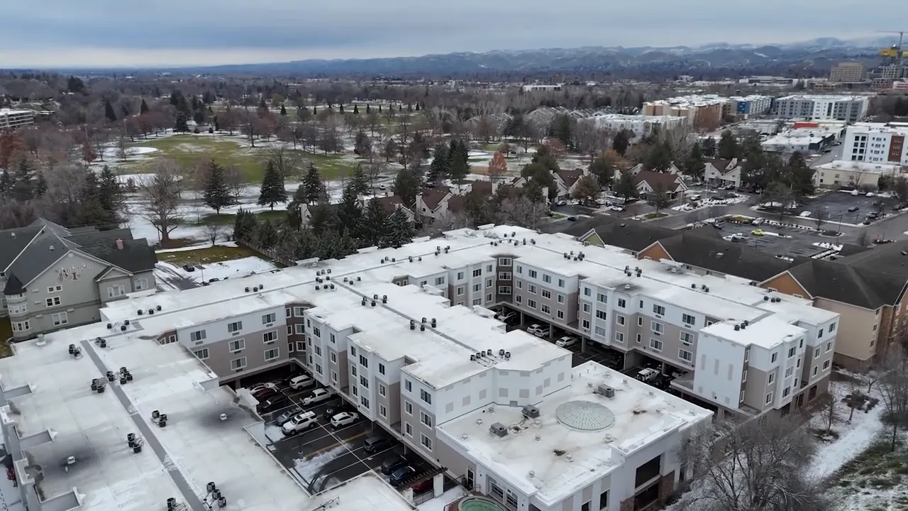 Aerial neighborhood view with text showing Boise median price 575000 dollars