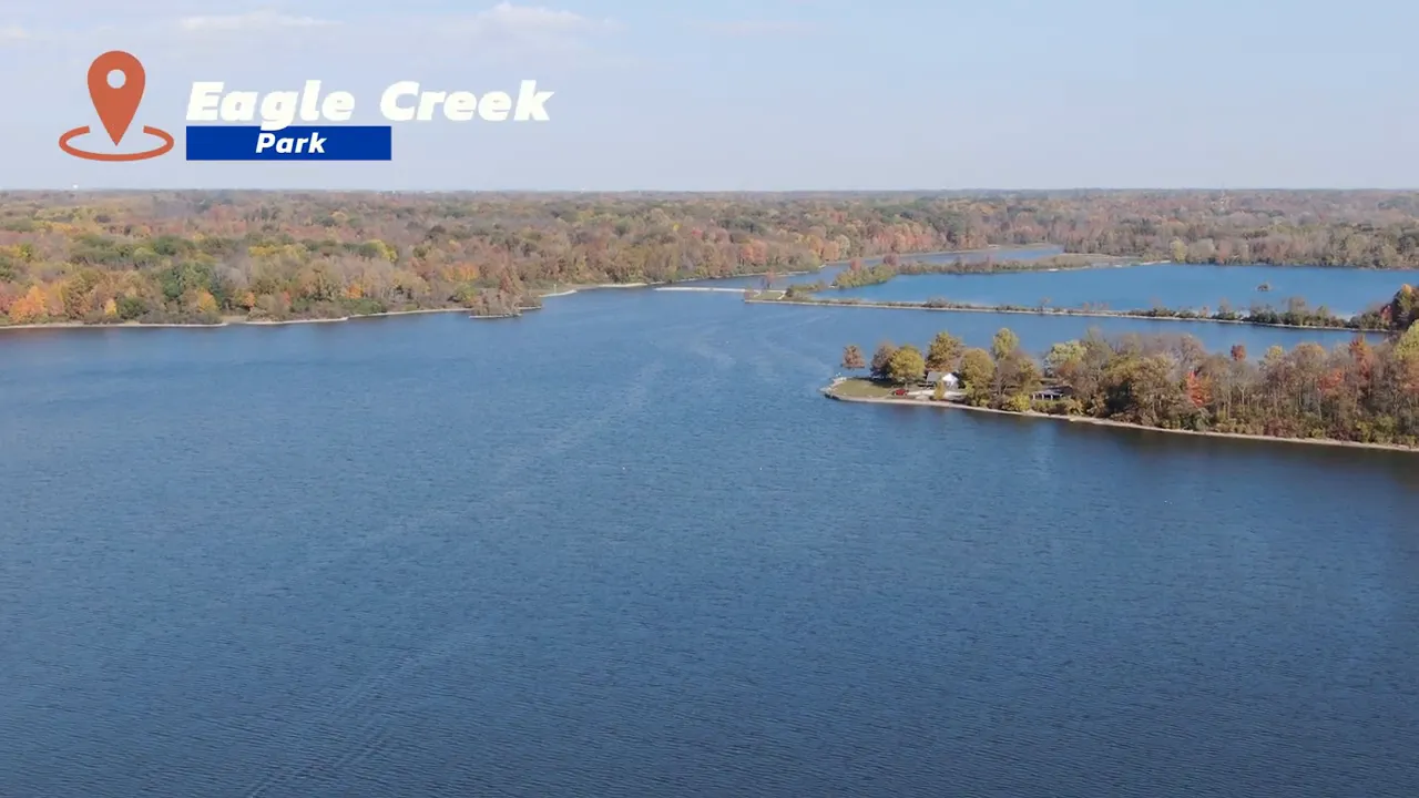 Wide aerial view of Eagle Creek reservoir and wooded shoreline with park label