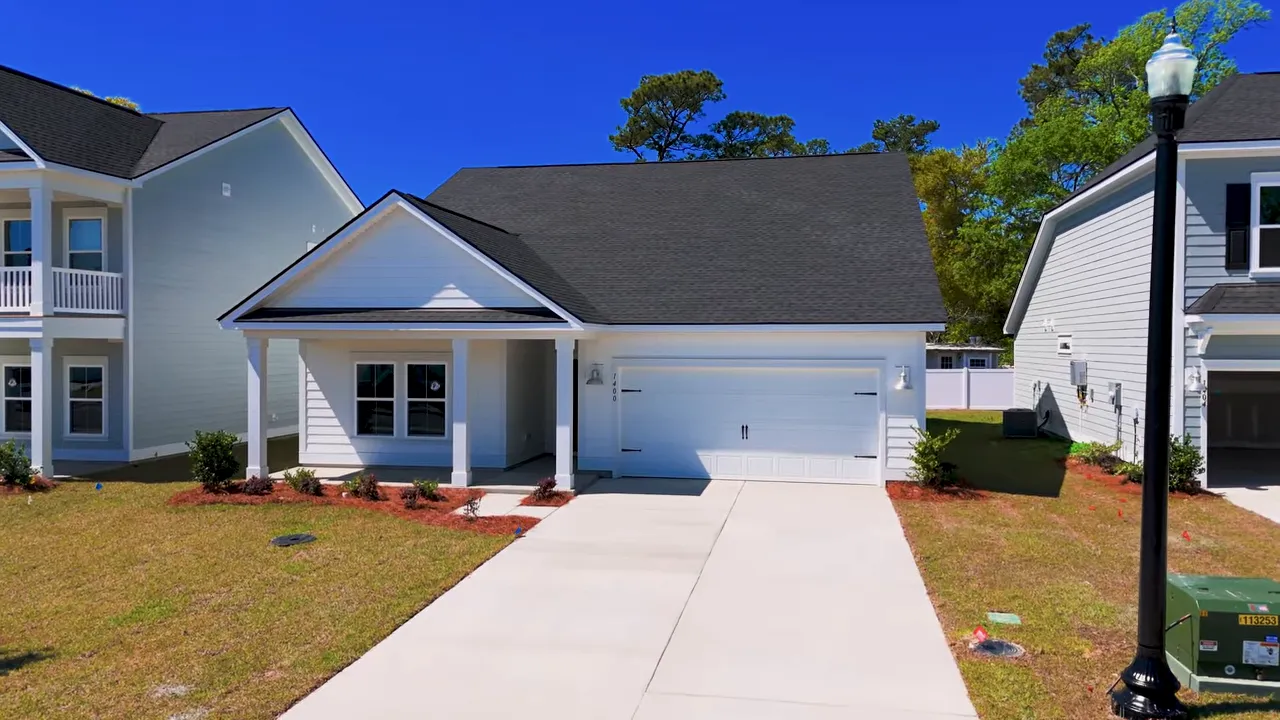 Bright unfurnished bedroom with window and neutral walls in a North Myrtle Beach home