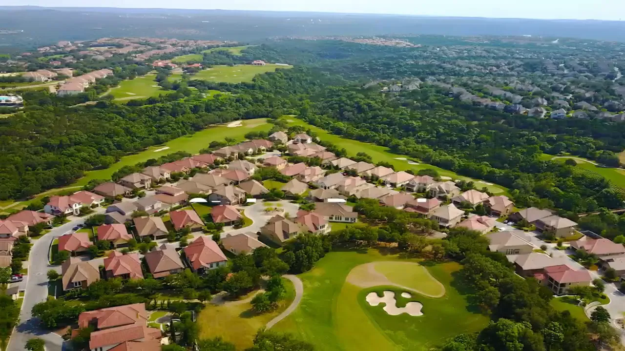 Aerial view of Steiner Ranch neighborhood with homes and golf-course-like green areas