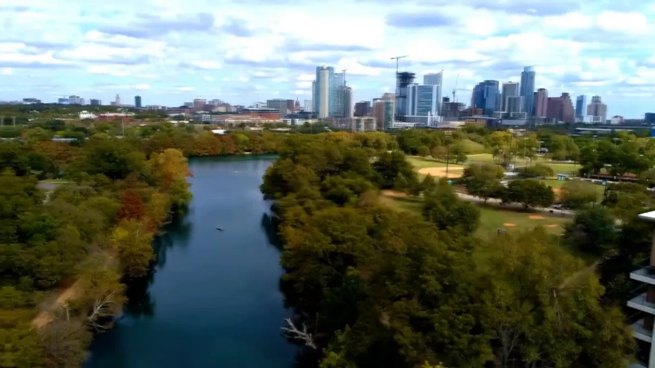 Aerial view of Barton Creek area with the Austin skyline in the background