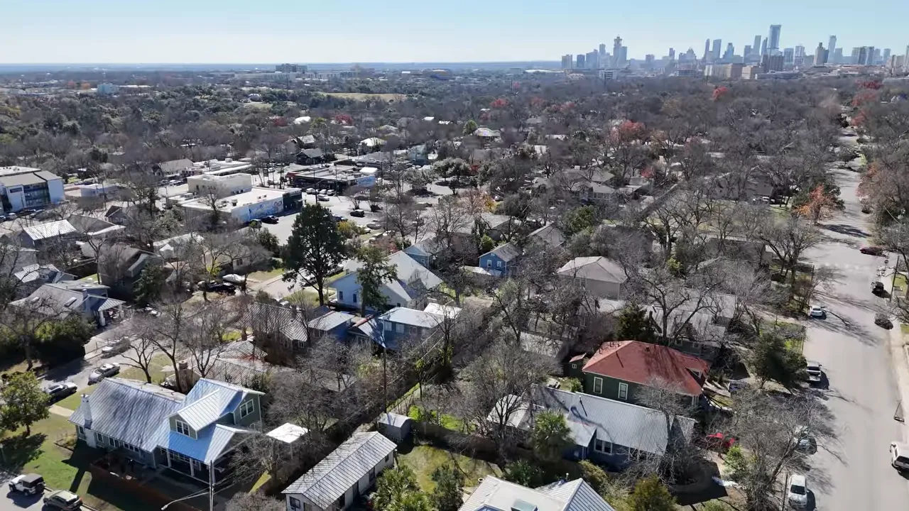 Presenter next to on-screen text reading 'Most realtors only share county-wide stats' with a living-room background.