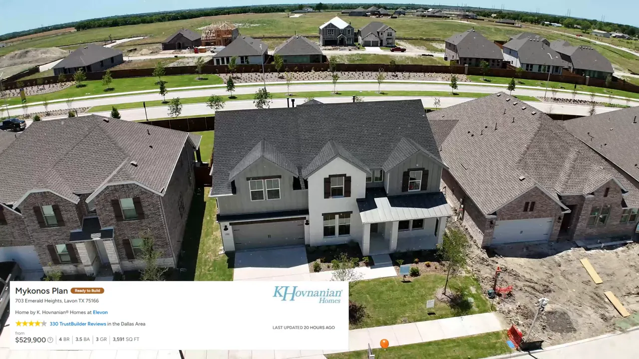 Aerial view of a two story home in Elevon with surrounding homes and streets