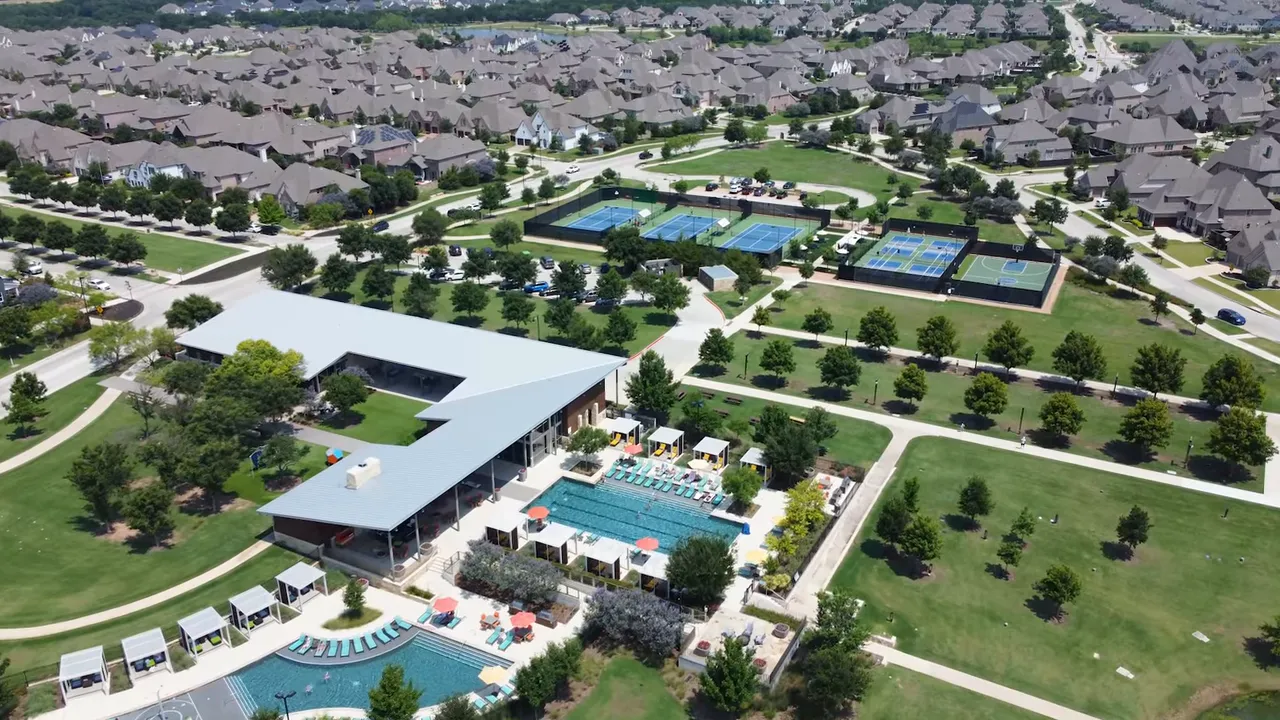 Presenter facing camera with on-screen title 'Predictions for the 2026 New Construction Housing Market' and numbered prediction icons.