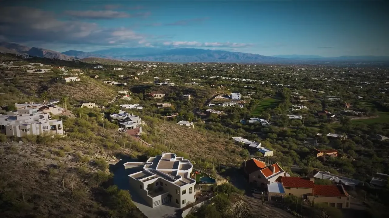 Aerial view of large homes spread across desert hillside lots