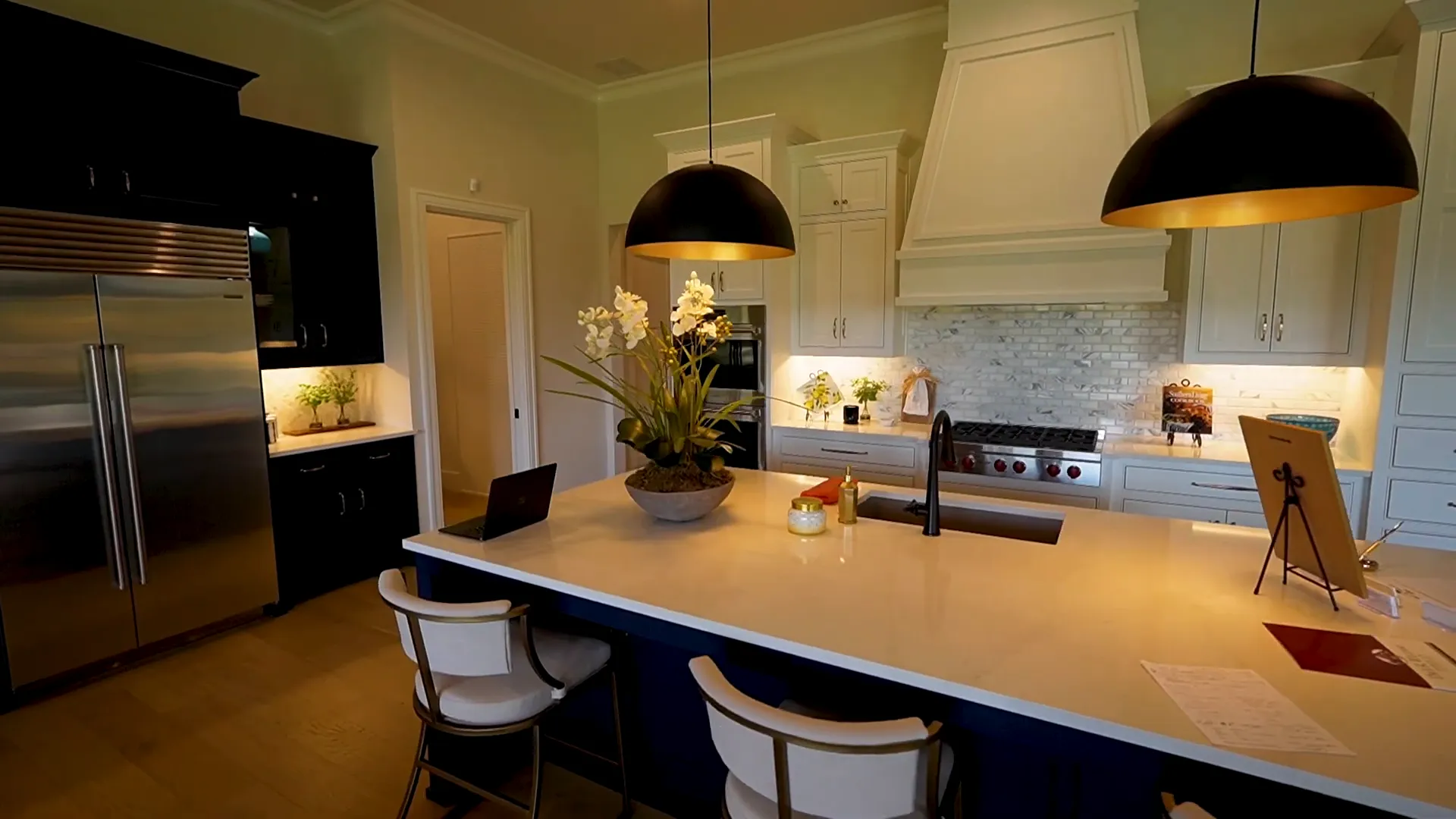 Huge kitchen island with navy blue wood wrap and seating