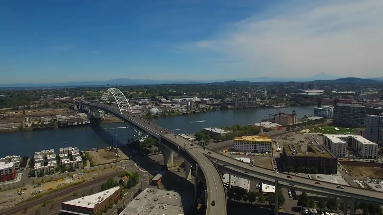Aerial view over Portland Oregon metro area with neighborhoods and hills in autumn