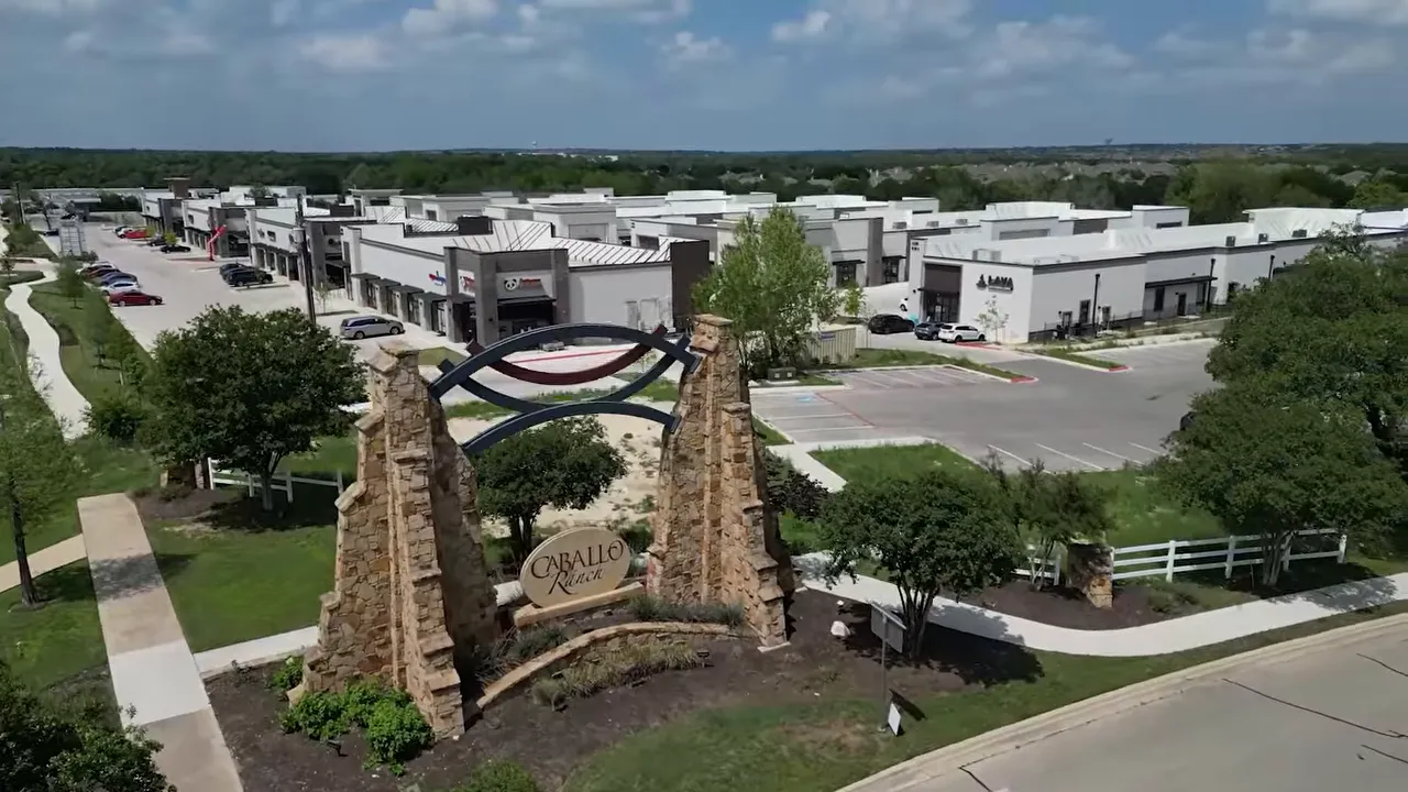 Aerial view of Caballo Ranch with tree-lined streets and established neighborhood homes in Cedar Park TX