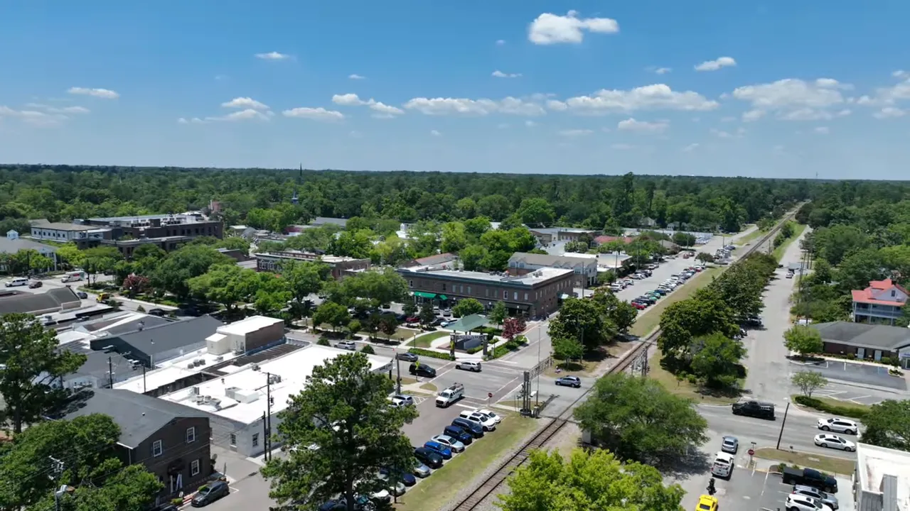 Street view of a Summerville neighborhood with multiple cars parked along the curb highlighting potential parking constraints.
