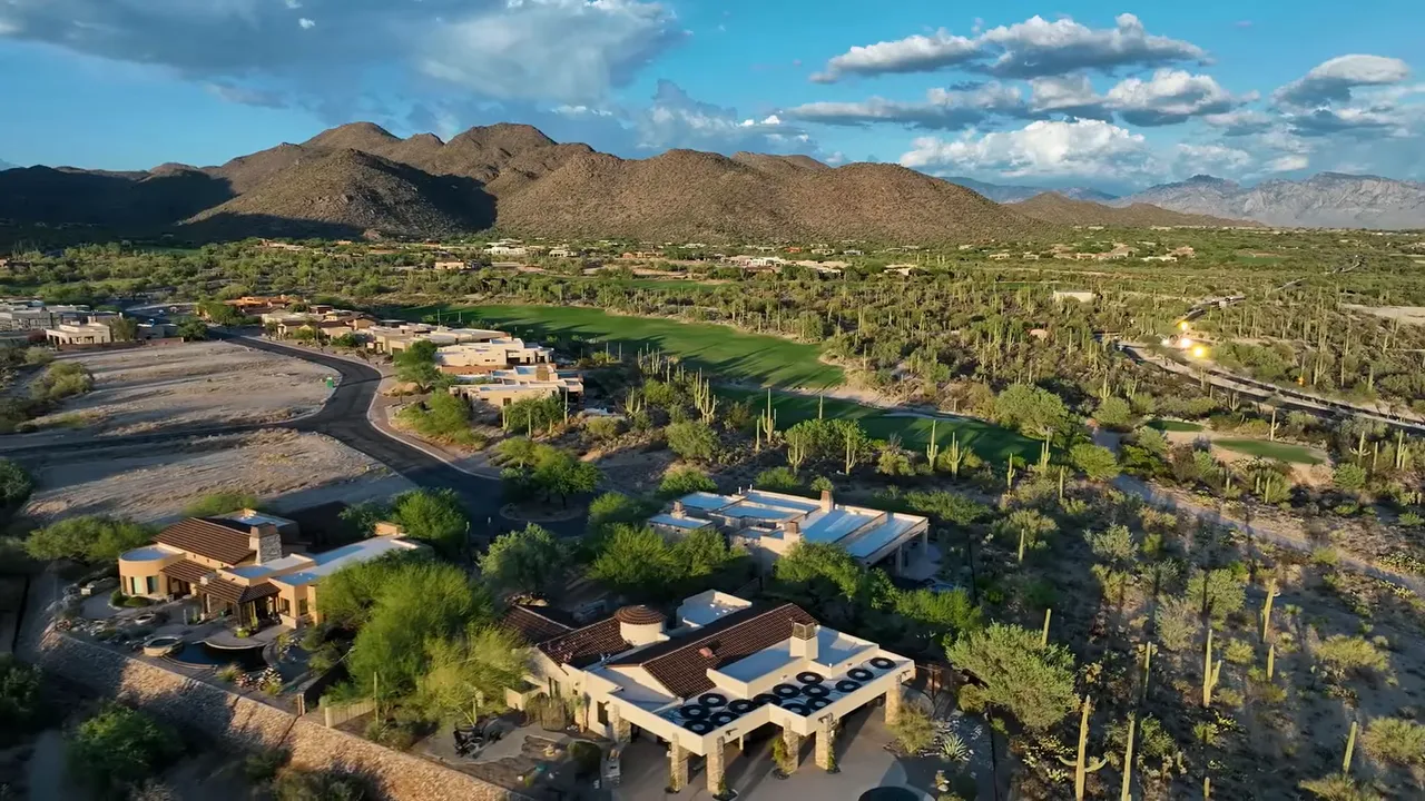 Aerial view of golf course fairway and bunkers surrounded by desert vegetation