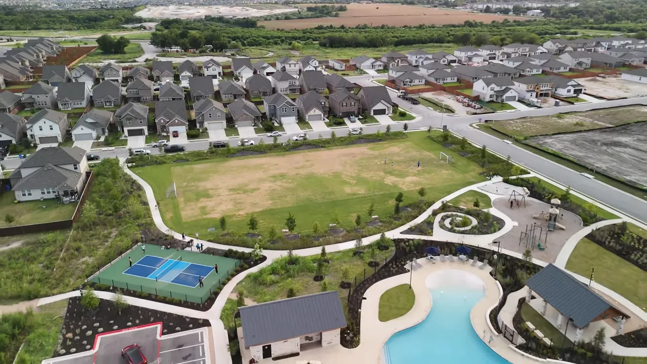 Aerial view of suburban new-construction neighborhood with large overlaid text reading 'THE BIG PICTURE'.