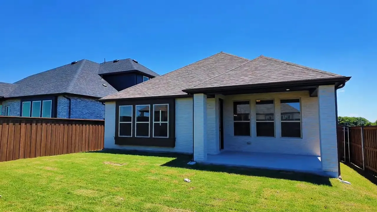 Close view of fenced backyard gate and wood privacy fence on a new construction home
