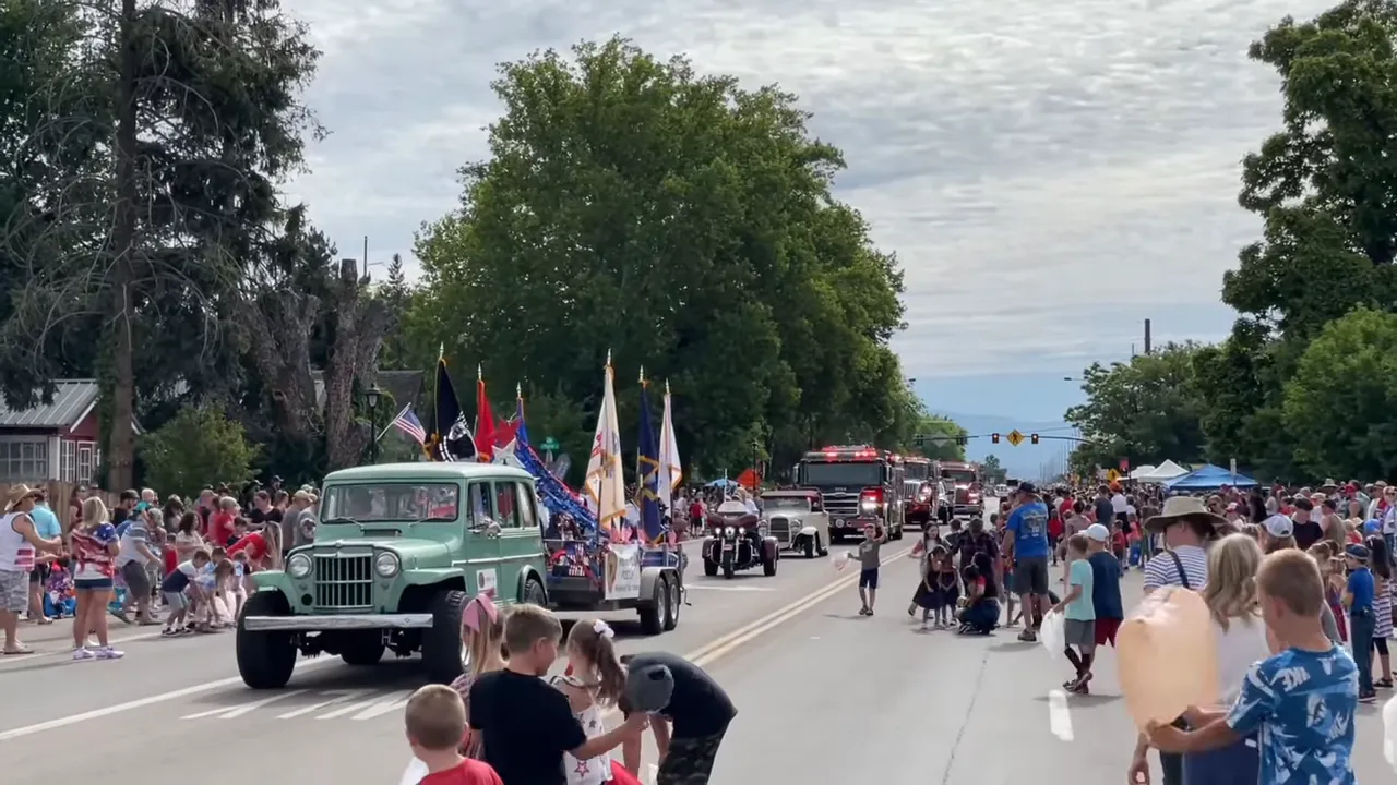 Firefighter and police car interacting with community