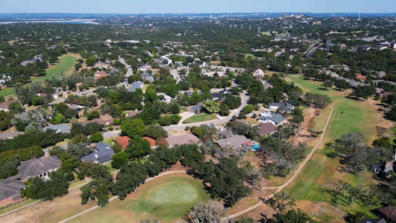 Downtown Austin streetscape with presenter on the sidewalk outside an office building