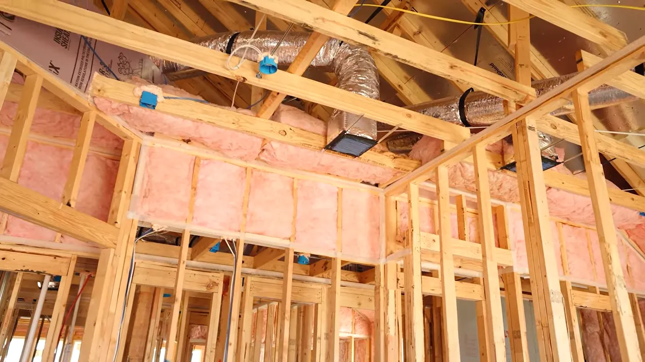 Open pre-drywall framing during a new construction walkthrough in DFW