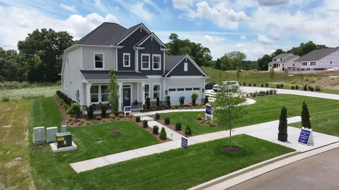 Aerial view of homes under construction along a curved road in the community