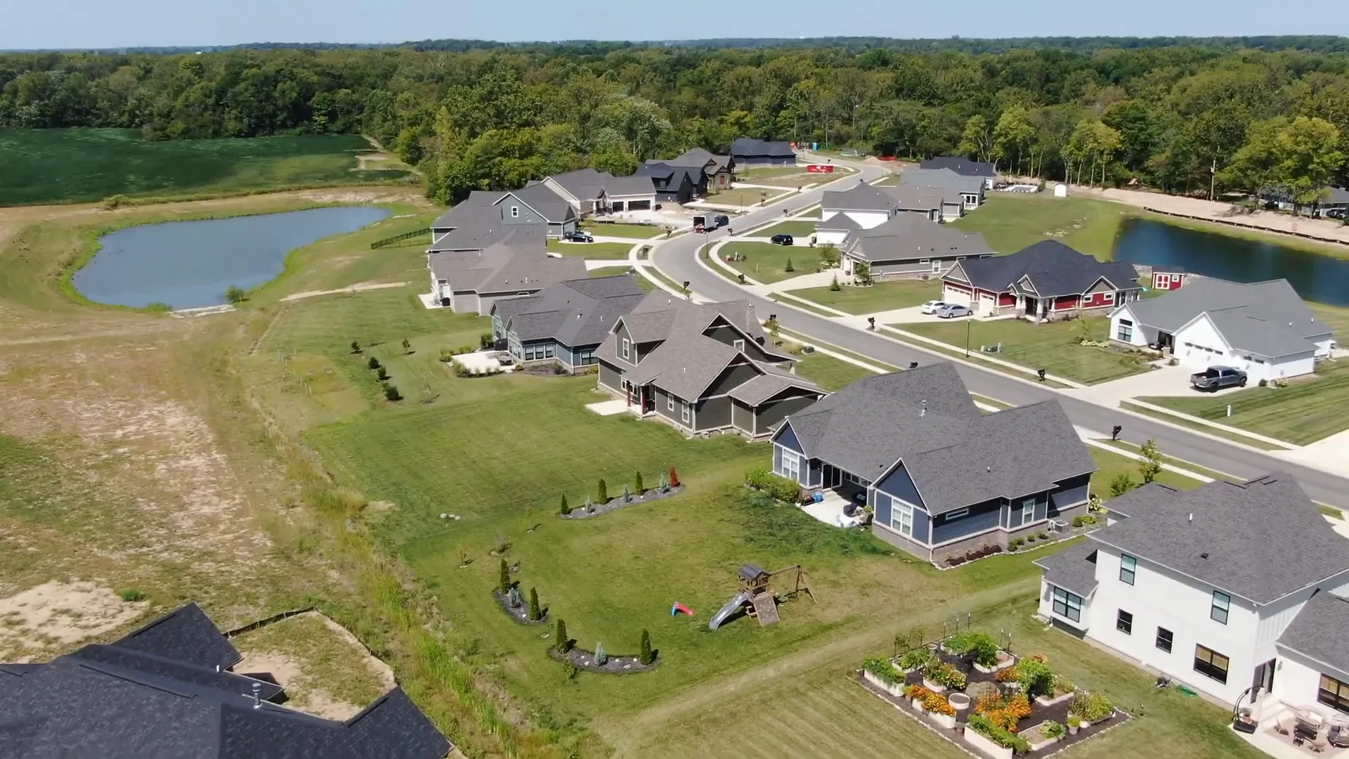 Neighborhood street scene in Hancock County with new homes
