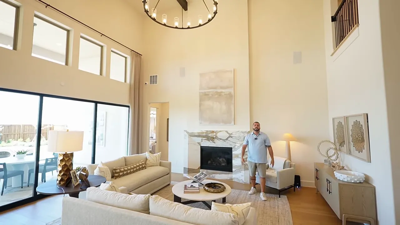 Two-story great room with beam detail and center fireplace