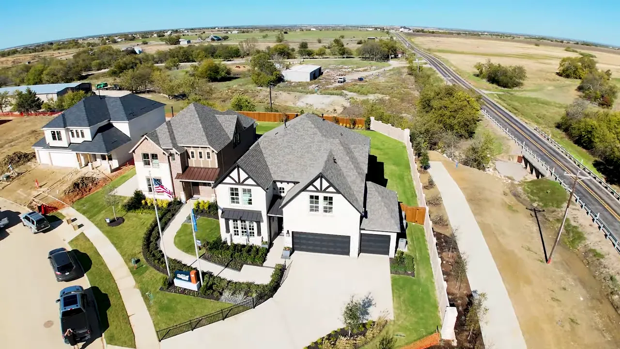Interior front staircase with dark handrail and iron balusters at La Terra model home