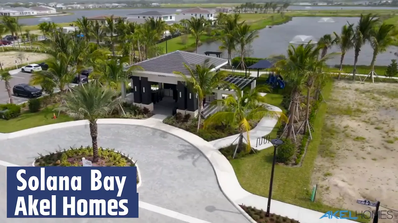 Aerial view of Solana Bay by Akel Homes within Avenir Palm Beach Gardens showing homes, landscaping, and lake area