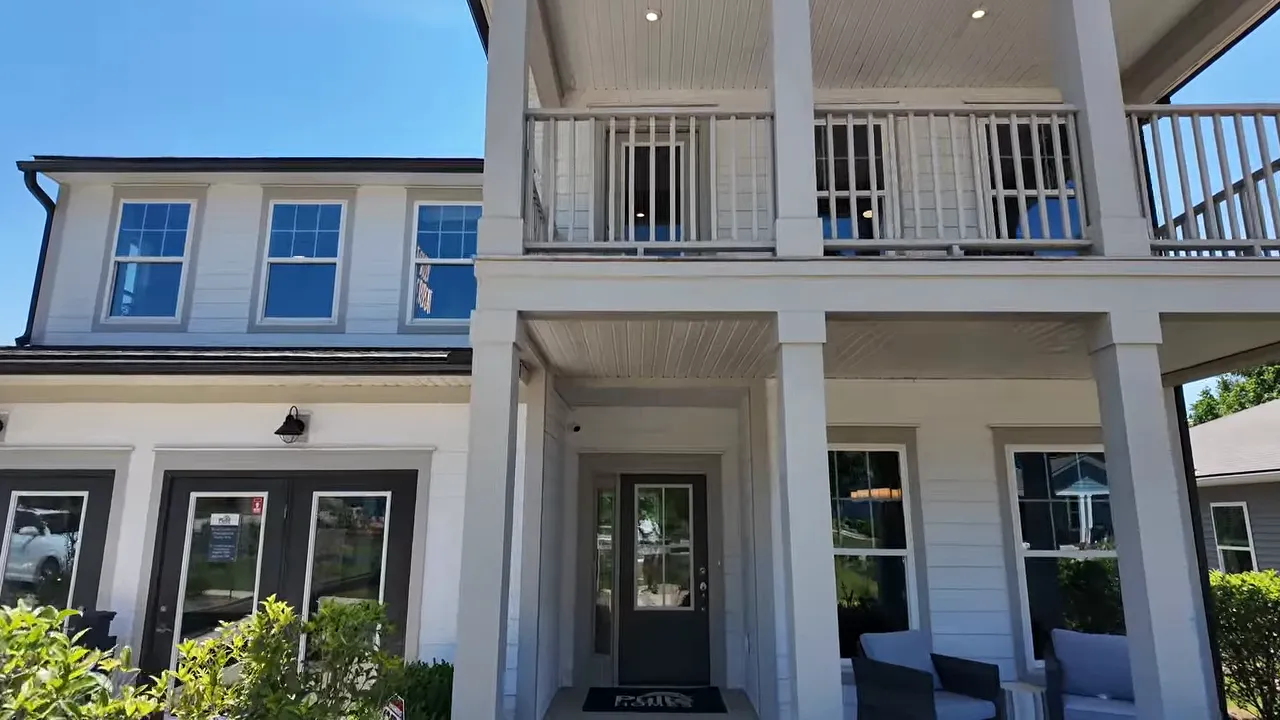 Covered front porch with outdoor seating and white columns