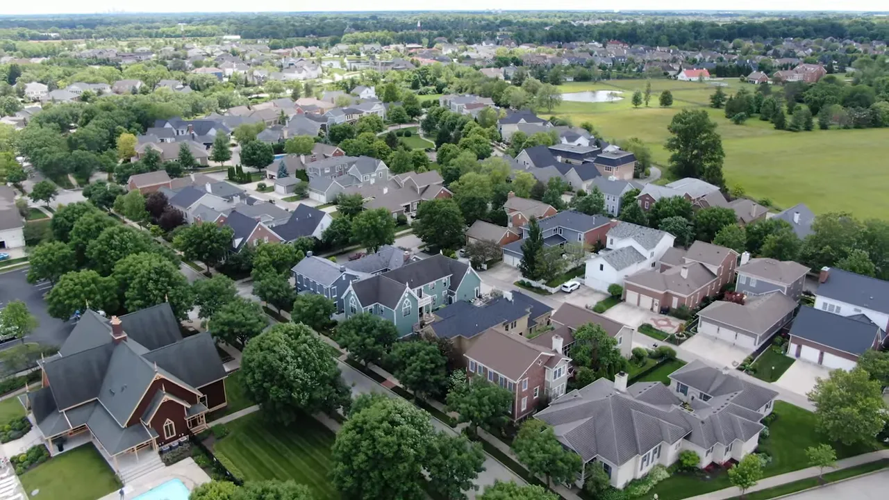 Wide sidewalk lined with mature trees in the Carmel neighborhood