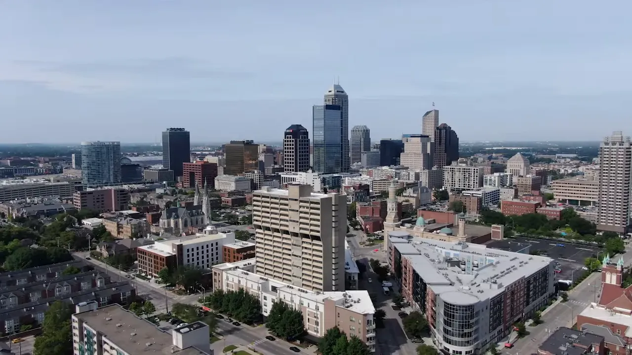 Presenter with on-screen bullet list: 'Newer Subdivisions', 'Heavy Builder Activity', 'Further from Job Centers'