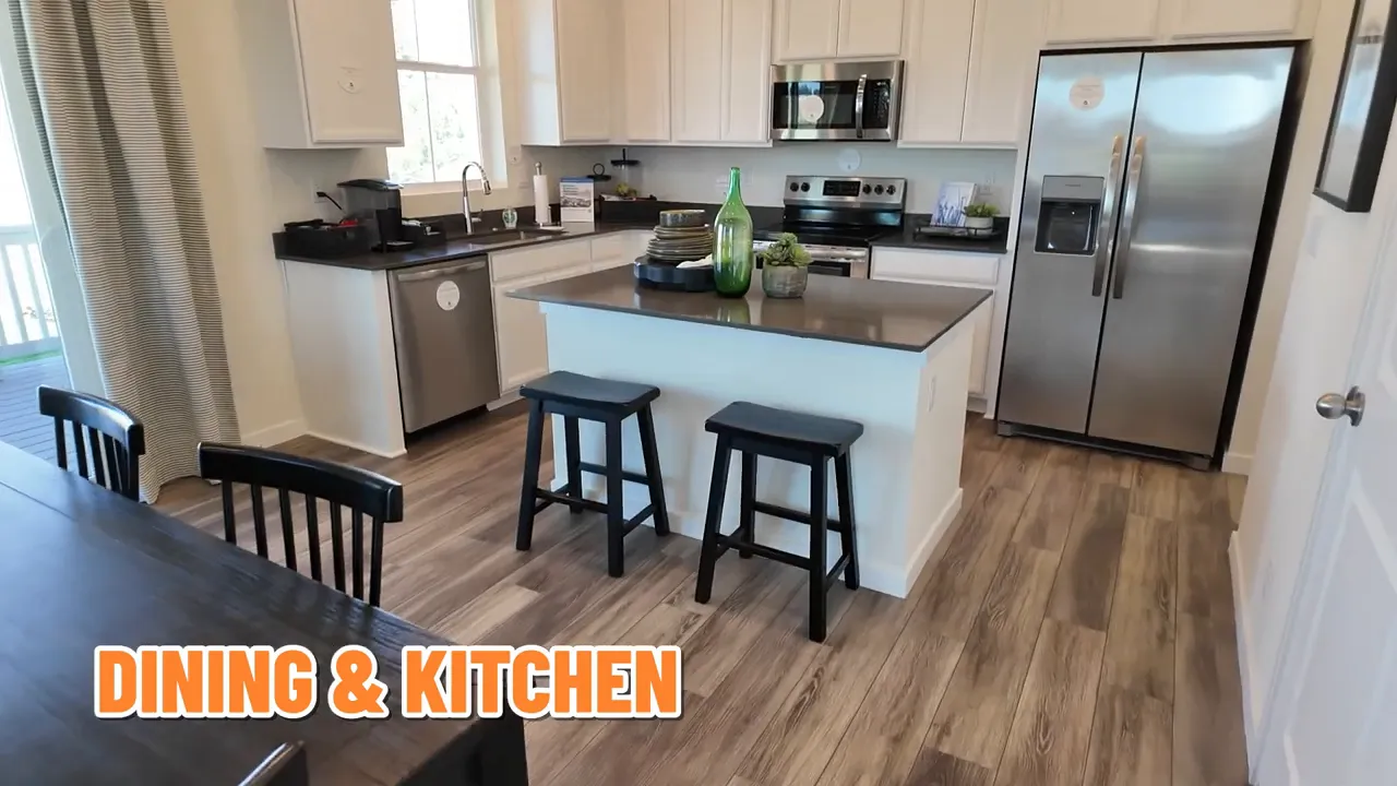 Kitchen island with slate quartz countertops and stainless steel appliances in the Lennar Tabor model at Independence subdivision in Elizabeth, Colorado