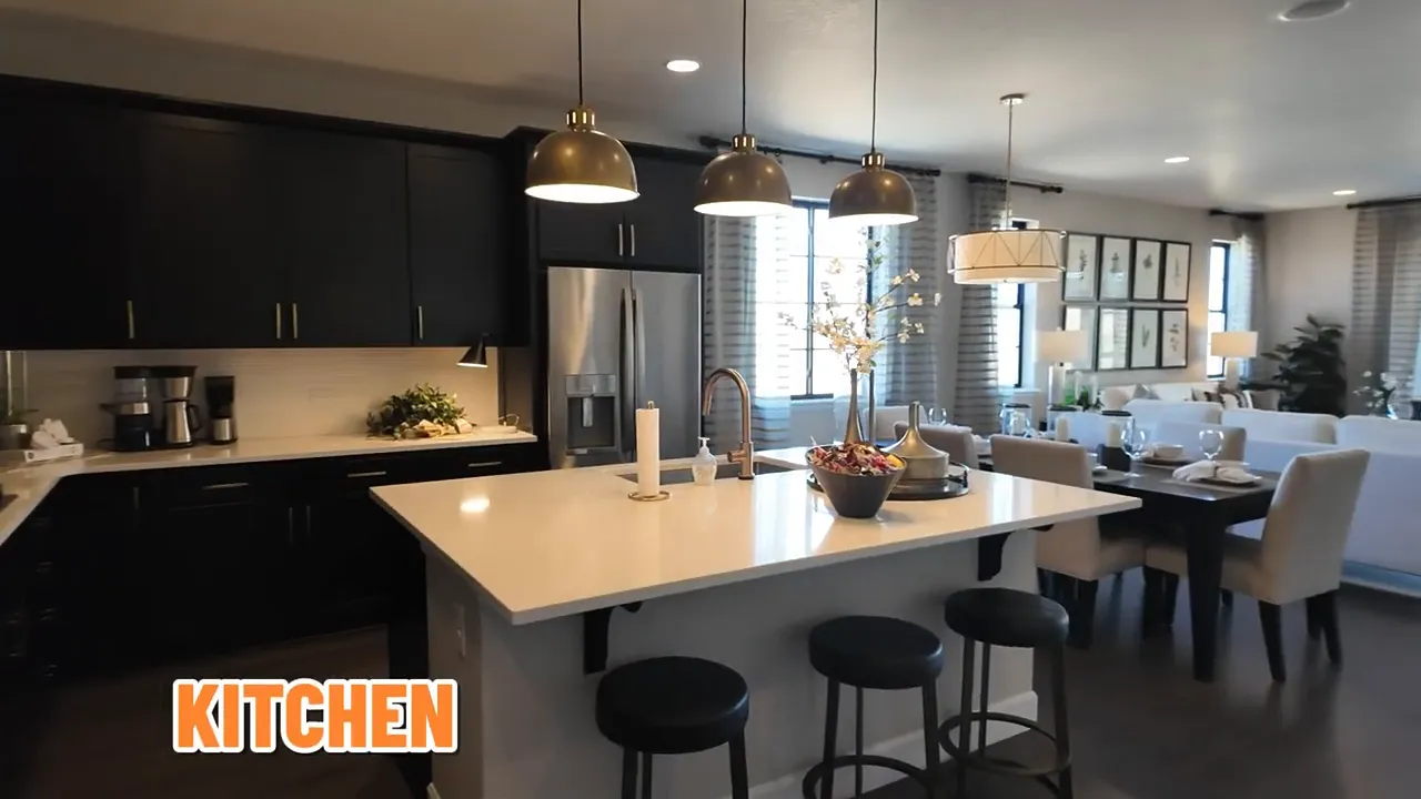 Open-concept view of kitchen, dining, and living areas in the Arlington model home at Independence subdivision, Elizabeth Colorado