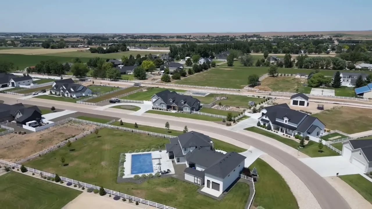 Aerial view of a downtown area with an outdoor ice skating rink, nearby shops and visitors.