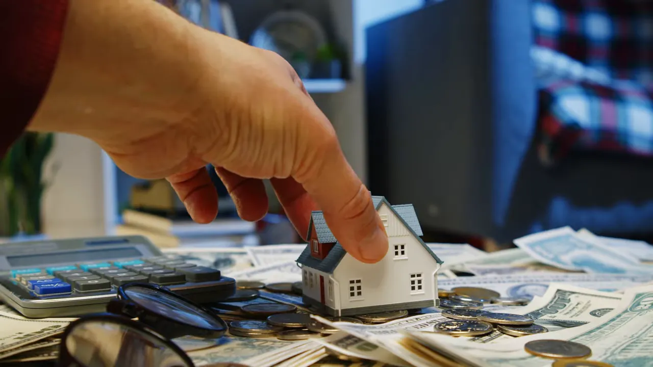 Couple carrying moving boxes into a living room with packed boxes and a visible 'SECTION 1' overlay, representing moving into a new home.