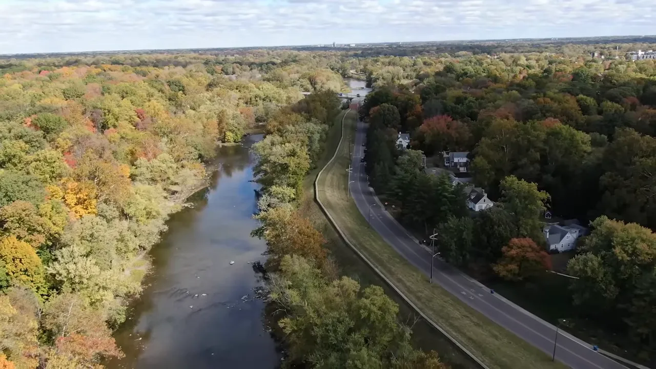 Aerial view of a river, levee/embankment and adjacent homes showing a potential floodplain near Indianapolis