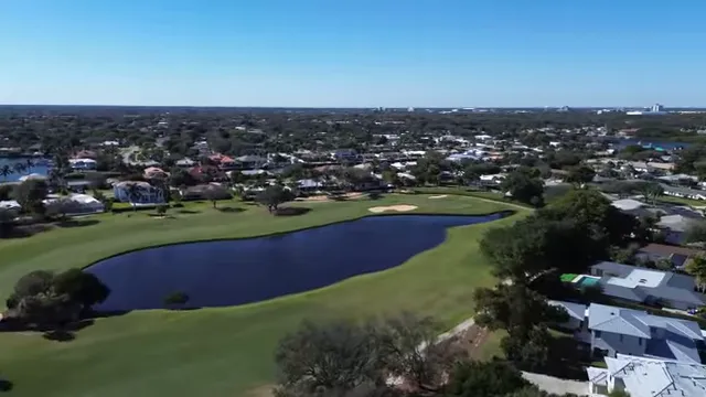 Aerial view of North Palm Beach Country Club and surrounding golf course with text reading empty nesters and retirees