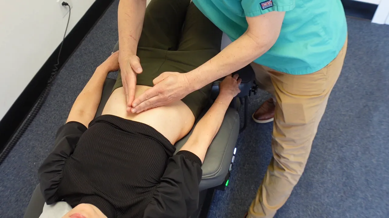 Outlining the ribs with fingers to show angled 'teepee' rib shape