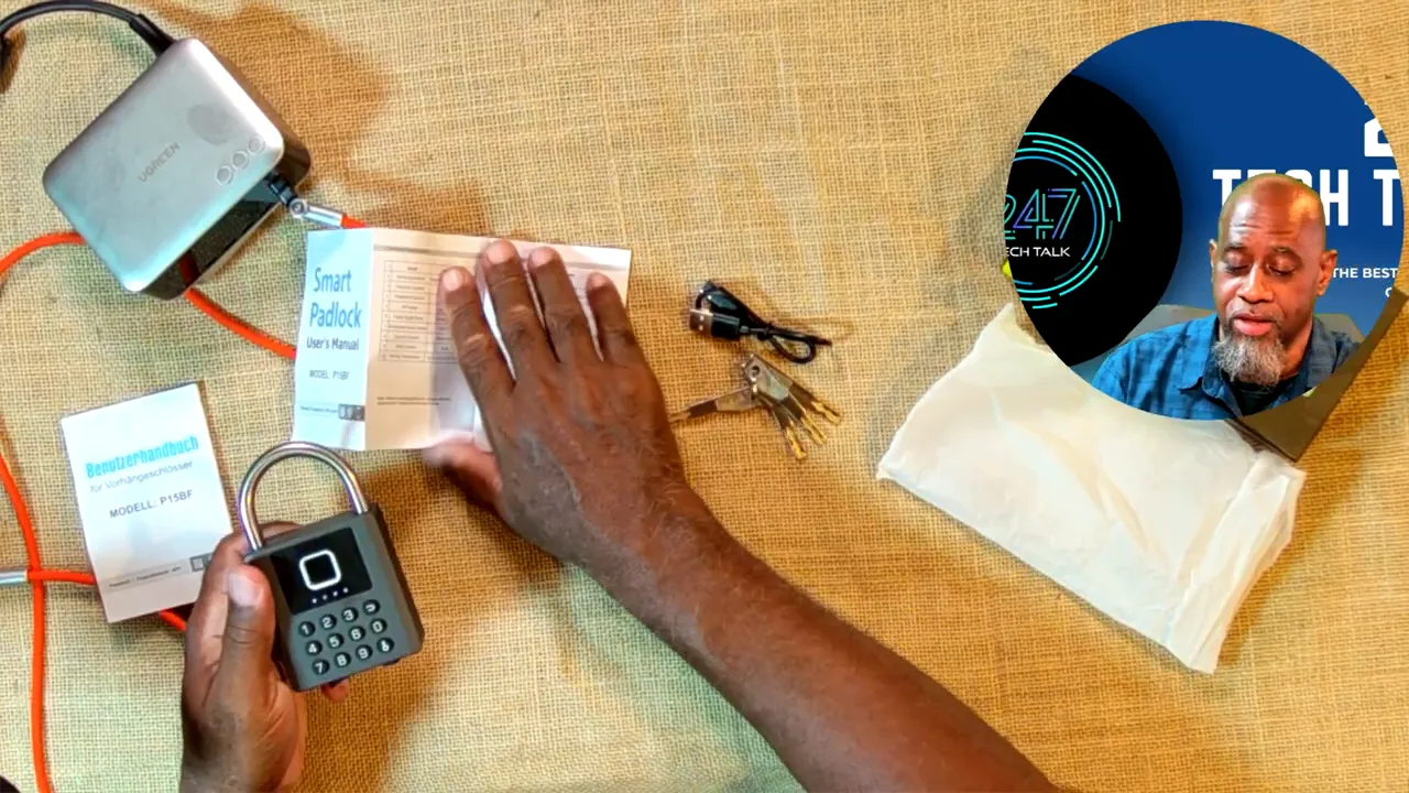 Smart padlock on a table with four keys, charging cable, paperwork and pouch