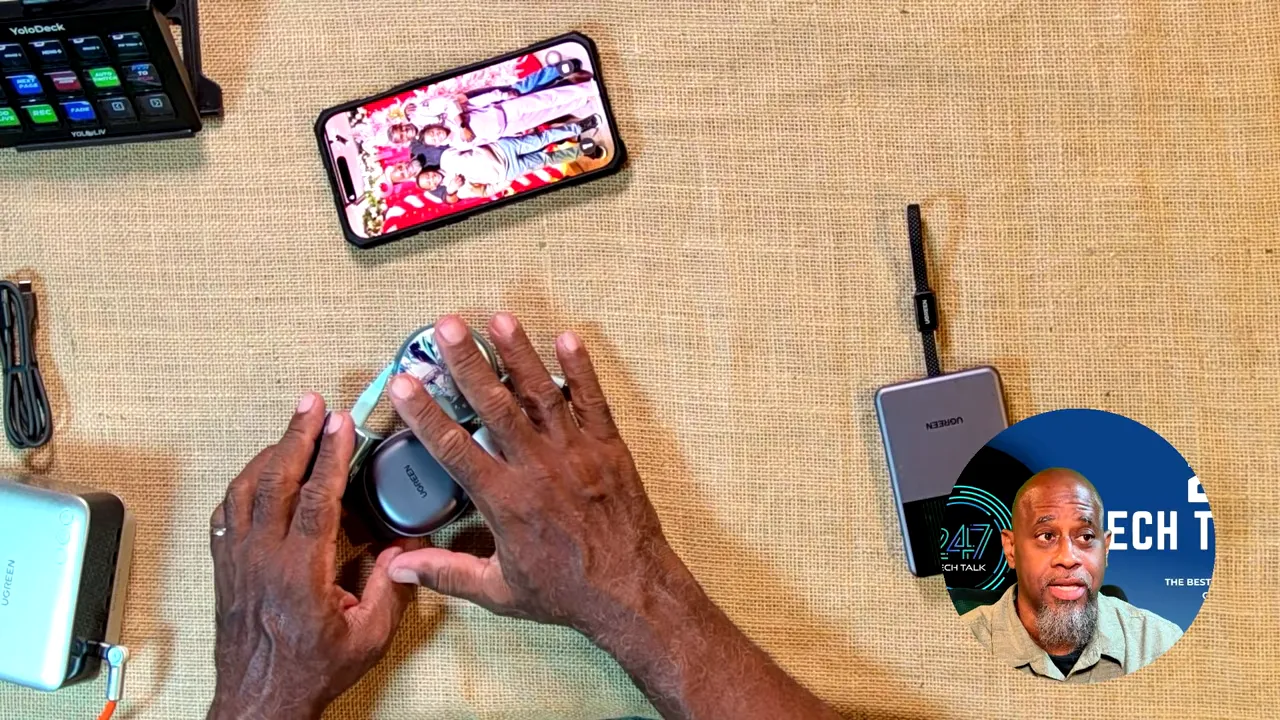 Open two-in-one wireless charger holding a white AirPods case beside travel charging accessories