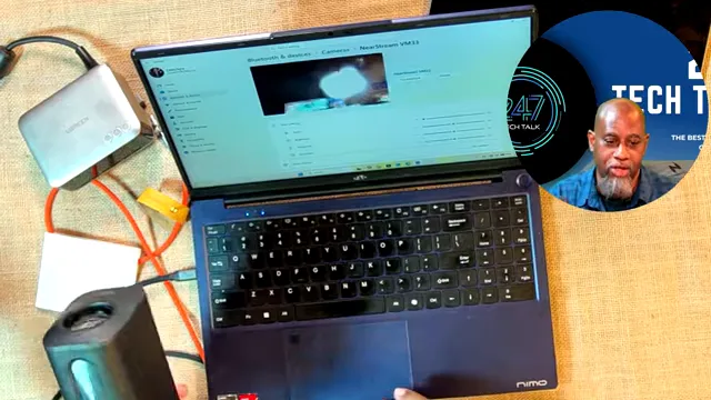 Laptop showing a camera video feed while a compact camera is connected by cable