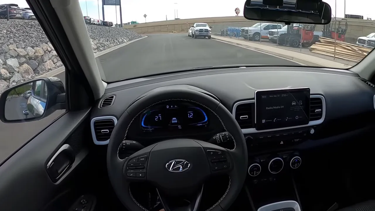 Hyundai Venue interior with steering wheel, clear road ahead and digital instrument cluster