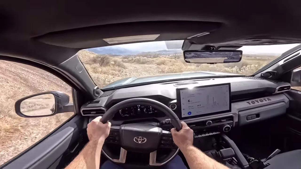 Driver point-of-view dashboard and steering wheel with central screen in Toyota Trailhunter