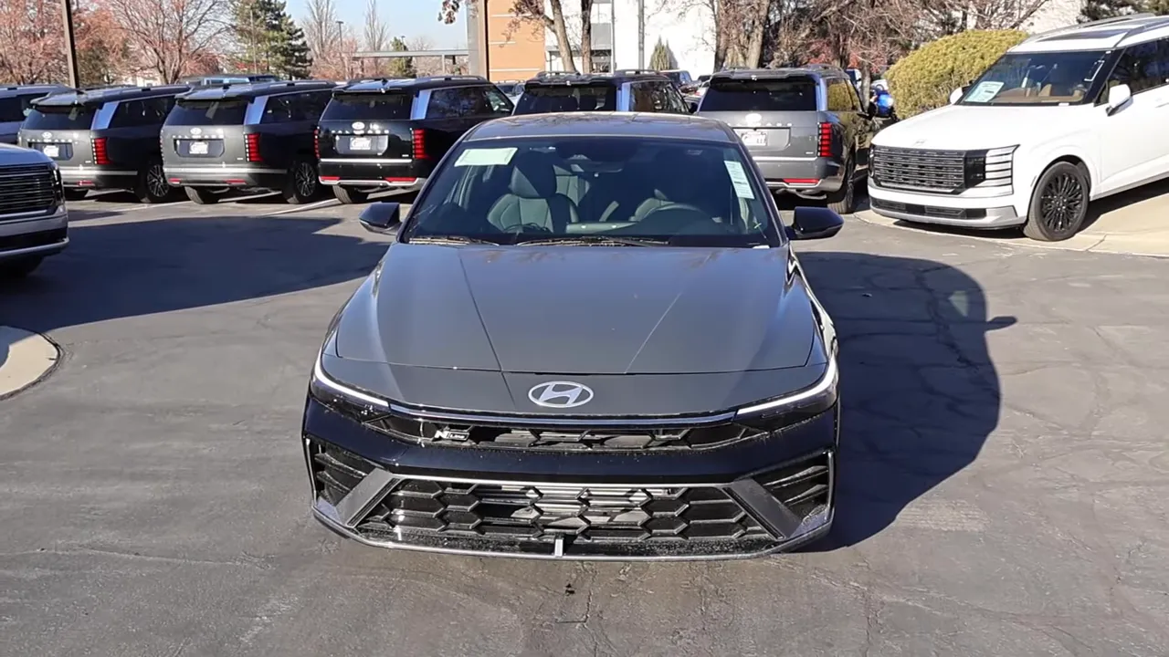 High-quality front-on shot of the 2026 Elantra N-Line showing the grille, Hyundai badge, slim DRLs, and aggressive lower valence.