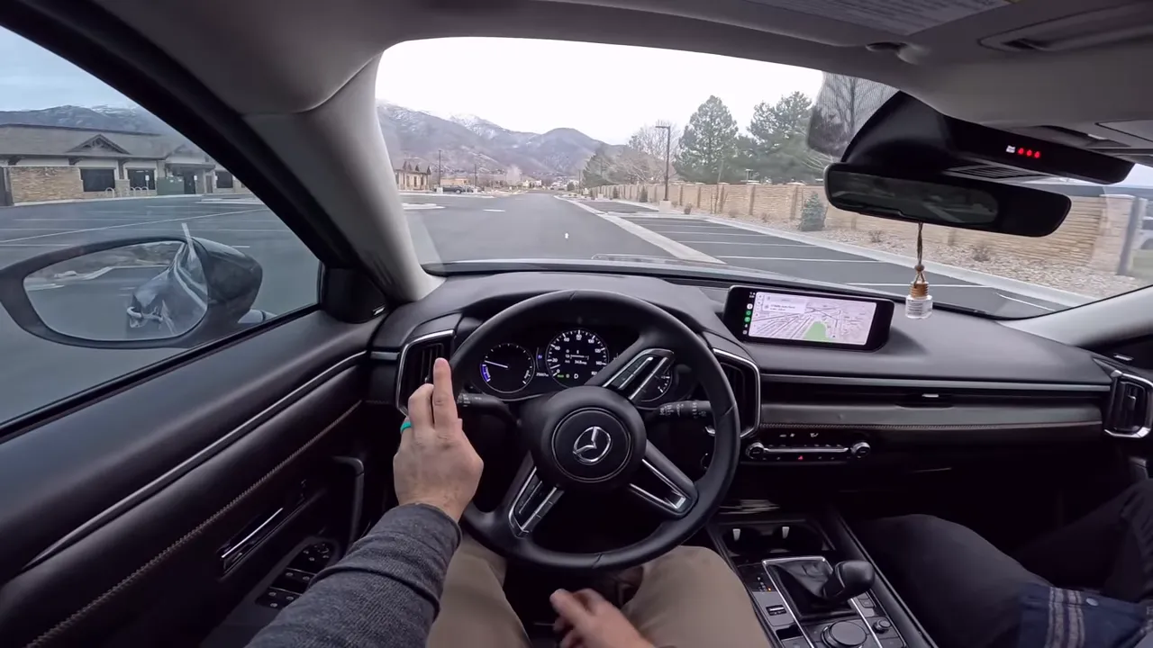 Mazda CX-50 instrument cluster and dashboard showing trip computer and navigation view